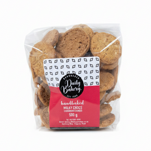 Packaged cookies with a 'Daily Bakery' label on a wooden surface.